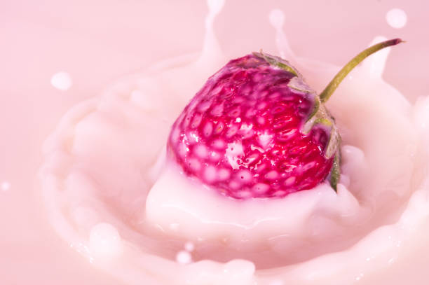 pure falling strawberry into milk with splash