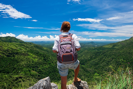 Caucasian girl stand to watch landscape from mini Adams peak in Sri Lanka