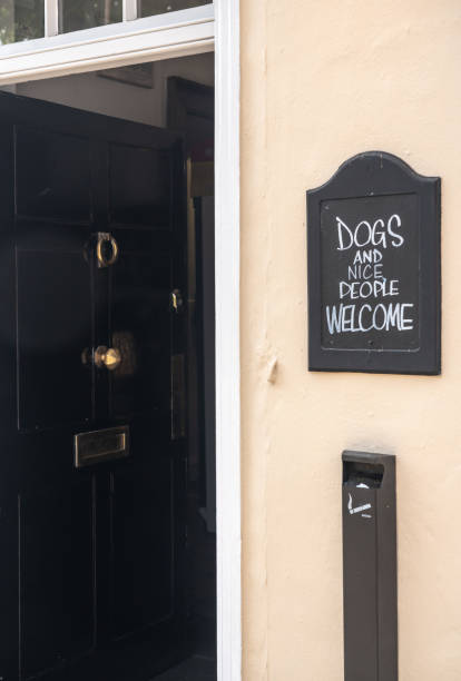 istock Signpost joke saying Dogs and nice people welcome 965782190