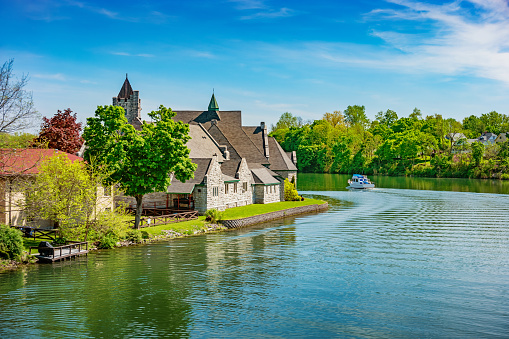 Stock photograph of Trinity Episcopal Church and the Cayuga–Seneca Canal in Seneca Falls, Finger Lakes region, upstate New York State, USA on a sunny day.