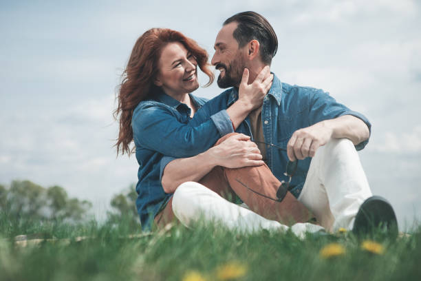 istock Glad loving couple relaxing on the meadow 965805486