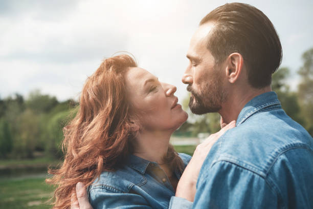 istock Adoring husband and wife hugging in the park 965805646
