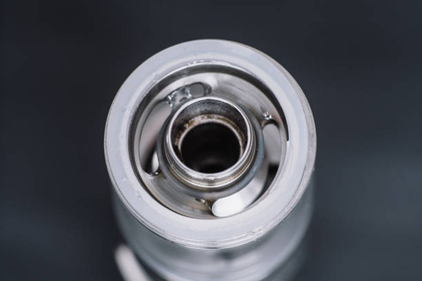 istock vape smoking an electronic cigarette, runs vape juice electronic cigarette. He holds a mechanical mod Vape Macro shot of fueling a 965833572
