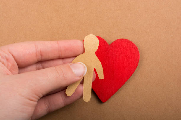 istock Paper man shape in hand in the view 965834674