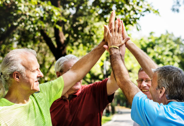 istock Group of senior athletes giving a high five 965880918
