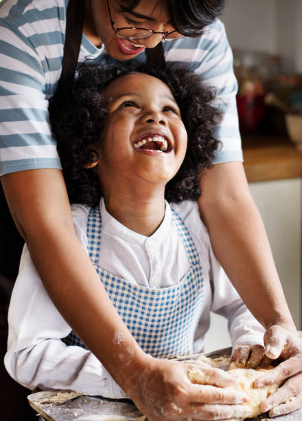 istock Mother and son kneading dough in the kitchen 965884832