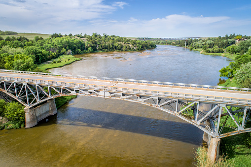 Niobrara River with a historic  pin-connected arch Bryan bridge built in 1932 near Valentine in Nebraska Sandhills, aerial perspective