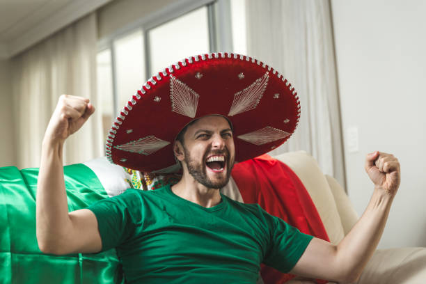 istock Mexican fan celebrating at home 965895888