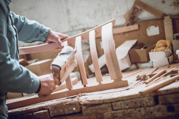 carpenter sanding the new chair he made - carpenter restoring furniture wood imagens e fotografias de stock