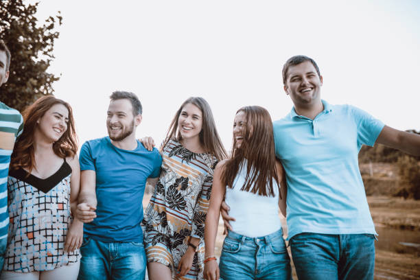 istock Group Of College Friends Taking A Walk In Summer Sunset 965948178