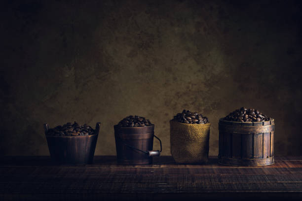 coffee beans in container on wood floor and old paper vintage aged background or texture