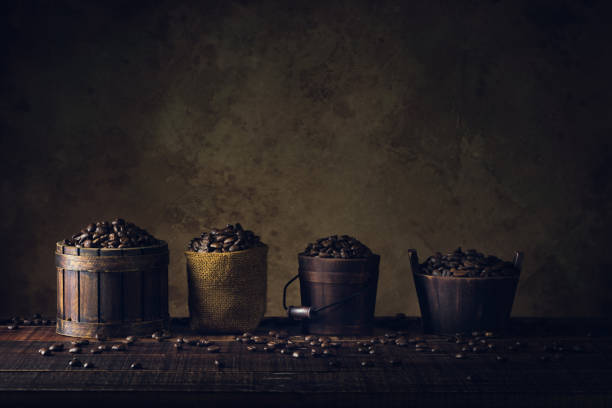 coffee beans in container on wood floor and old paper vintage aged background or texture