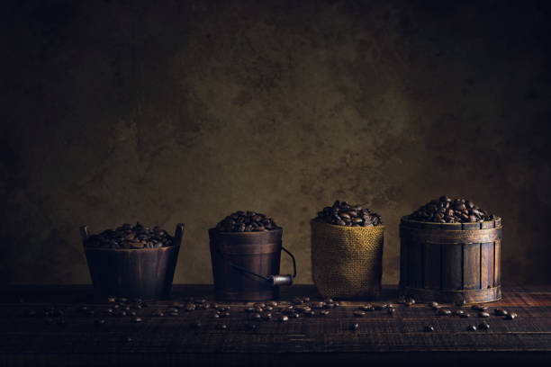 coffee beans in container on wood floor and old paper vintage aged background or texture