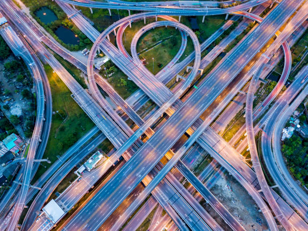 istock Top view of Highway road junctions at night. The Intersecting freeway road overpass the eastern outer ring road of Bangkok, Thailand. 965963164
