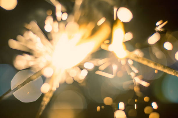 sparkler bokeh colorful sparkler. night background with a sparkler. - independence spark fire flame imagens e fotografias de stock