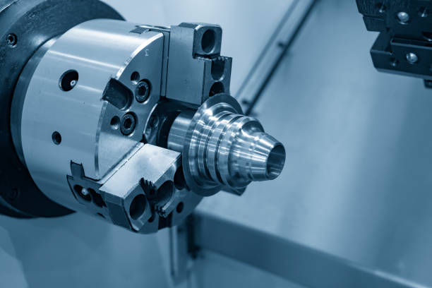 istock The CNC lathe or turning machine cutting the metal cone shape part in the light blue scene. 965971490