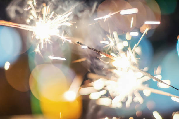 istock Sparkler Bokeh Colorful sparkler. Night background with a sparkler. 965979130