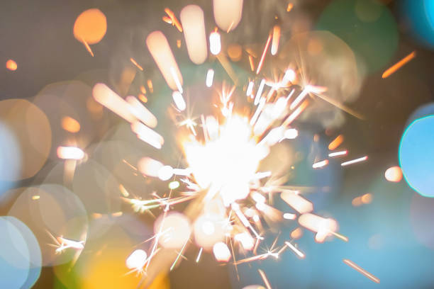 istock Sparkler Bokeh Colorful sparkler. Night background with a sparkler. 965979450