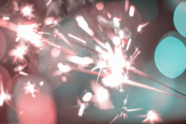 istock Sparkler Bokeh Colorful sparkler. Night background with a sparkler. 965983674