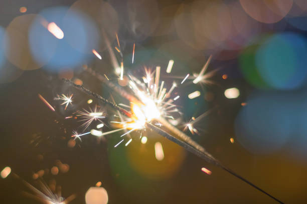 istock Sparkler Bokeh Colorful sparkler. Night background with a sparkler. 965984474