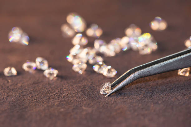 Diamond with tweezers and magnifier.Gemstone Beauty Diamond with tweezers and magnifier.Gemstone Beauty facet joint photos stock pictures, royalty-free photos & images
