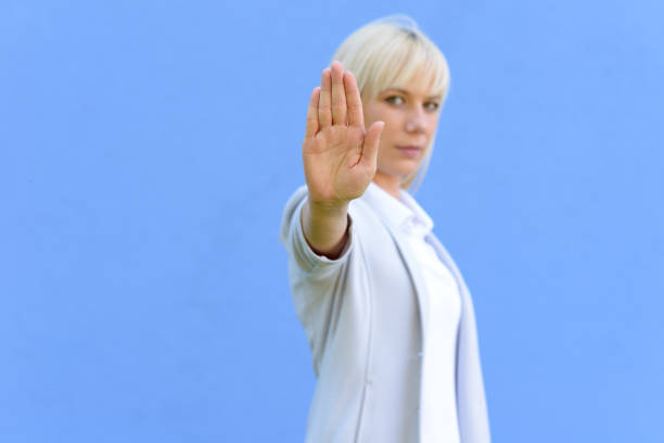 istock Blond woman giving a halt sign 966100312