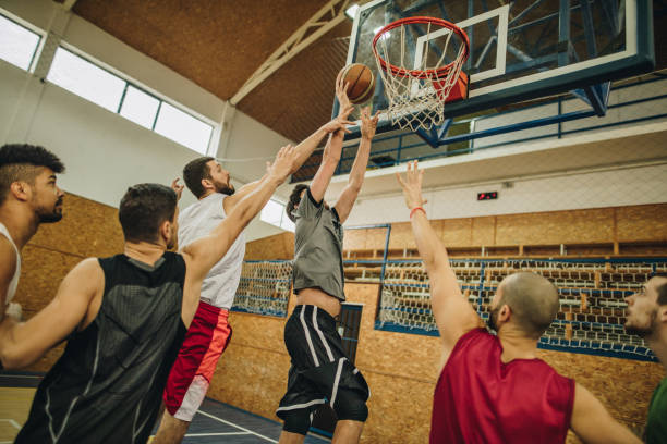 istock Group of young athletic men playing basketball. 966100868