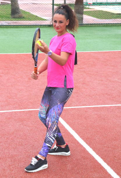 istock young tennis coach woman shooting 966110938