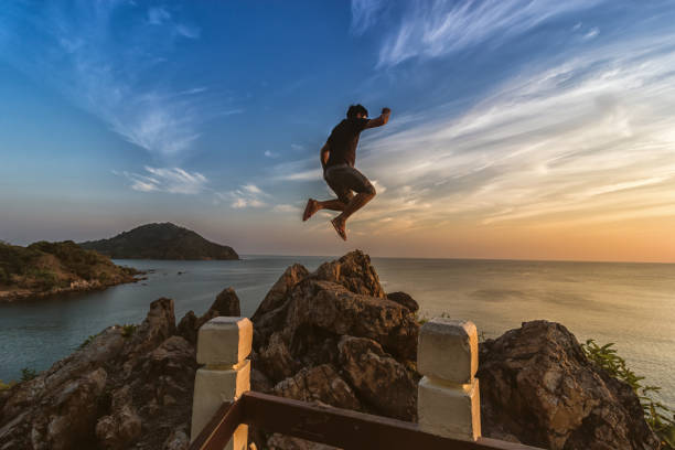 istock Tourists are jumping at sea view point at sunset. 966123836