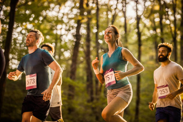 istock Marathon runners having a race through the forest. 966141966