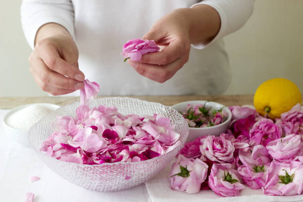 istock A woman prepares jam from roses, ingredients for jam from roses. Rustic style. 966158550