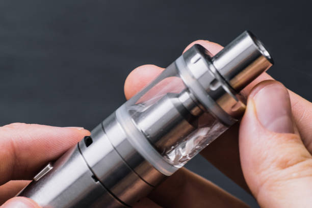 istock Vaping man Vape. holding a mod device. cloud of vape 966158944