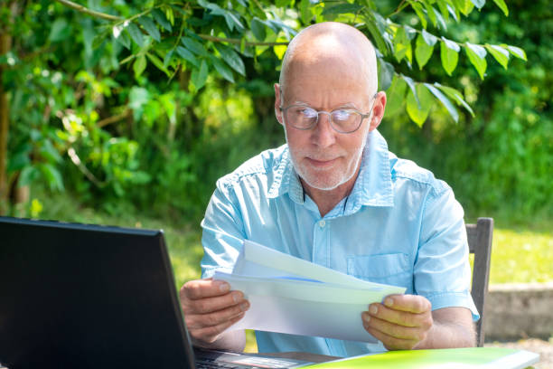 istock a handsome senior man reading the letter 966174492