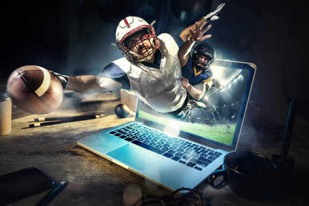 Collage about american football players in dynamic action with ball in a professional sport game. He playing on the laptop Collage about american football players in dynamic action with ball in a professional sport game. They playing from laptop. 3D model of the stadium was created by me (the author) match sport stock pictures, royalty-free photos & images