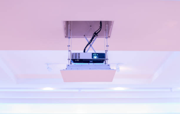 istock Projector installed on the ceiling of hotel conference room. Front view. 966187114
