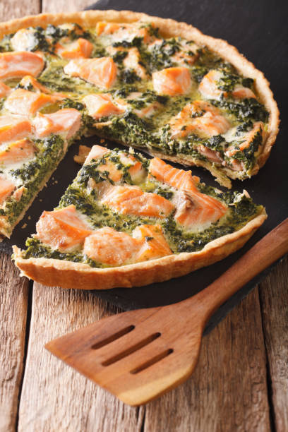 istock Tasty sliced Savory quiche with salmon and spinach, close-up. vertical 966191136