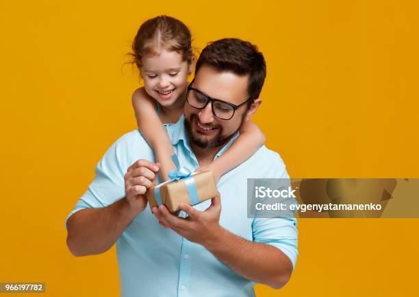 Happy Fathers Day Cute Dad And Daughter Hugging On Yellow Background Stock Photo - Download Image Now
