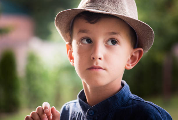 istock Boy wearing hat posing in the garden 966199078