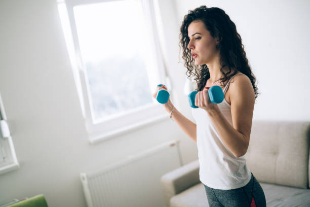 istock Young attractive sportswoman doing exercises at home 966199500