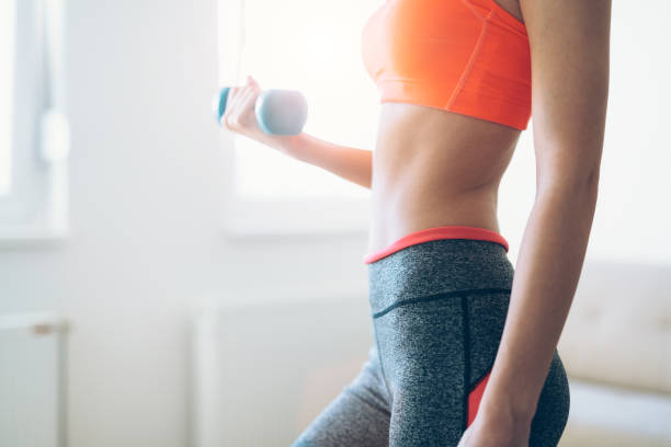 istock Young attractive sportswoman doing exercises at home 966200134