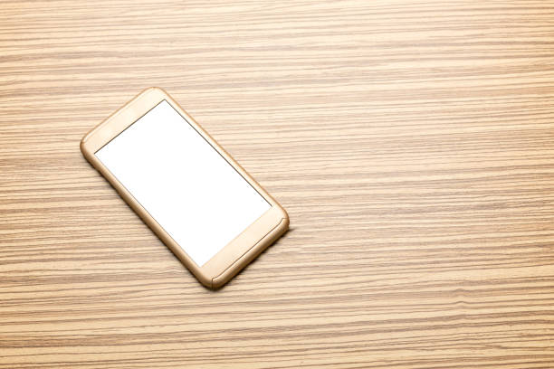 istock Smart phone on wooden background 966202898