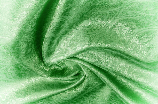 istock Background texture, pattern. Paisley Silk green Jacquard is a complex woven glossy fabric with a woven design. Weaving creates the effect of a 