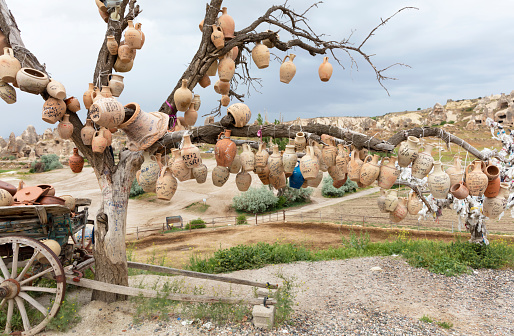 Goreme, Turkey - May 07, 2018: Tree Of Wishes with clay pots in Cappadocia. Nevsehir Province, Cappadocia, Central Anatolia, Turkey