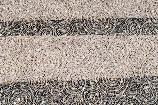istock Texture, fabric, background. Lace fabric with a pattern of a circle, with a thread of gold thread 966210334
