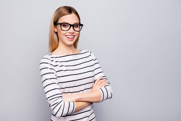 istock Portrait with copy space, empty place for advertisement of cheerful, attractive, positive, charming girl having her arms crossed looking at camera isolated on grey background 966218722
