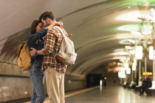 istock two stylish tourists embracing each other at subway station 966220094