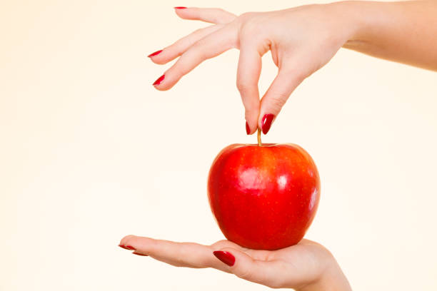 istock Woman hand holding delicious red apple 966220562