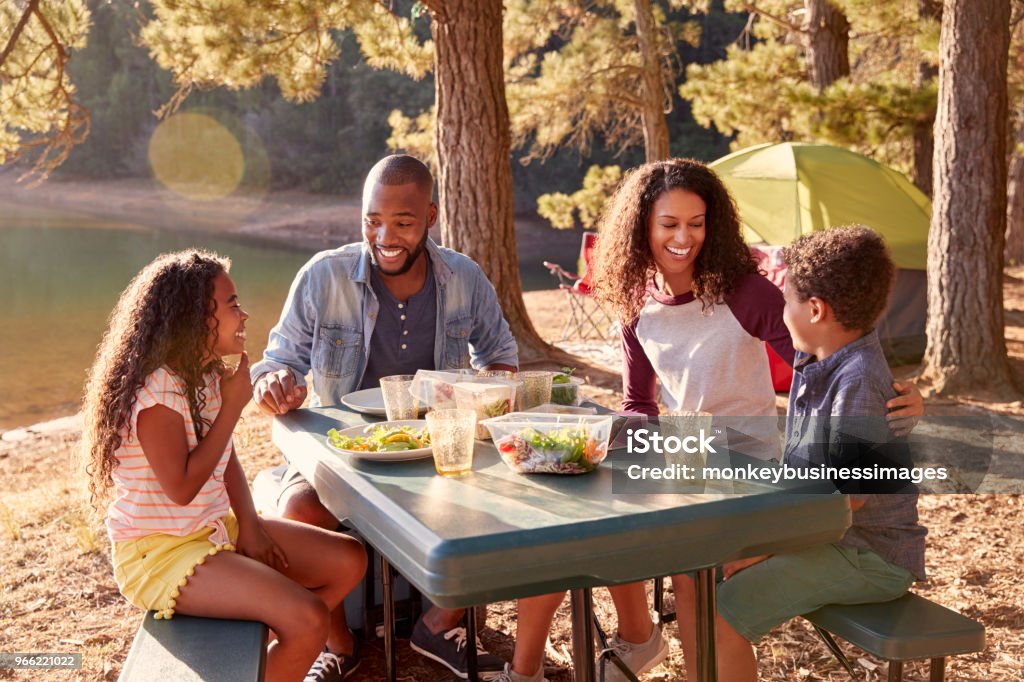 Family Camping By Lake On Hiking Adventure In Forest Family Stock Photo