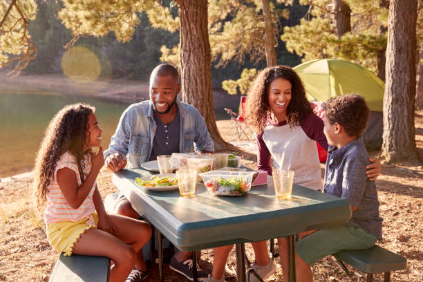 family camping by lake on hiking adventure in forest - vacations two generation family caucasian friendship imagens e fotografias de stock