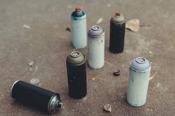 istock cans with colorful spray paint for graffiti on asphalt 966240138